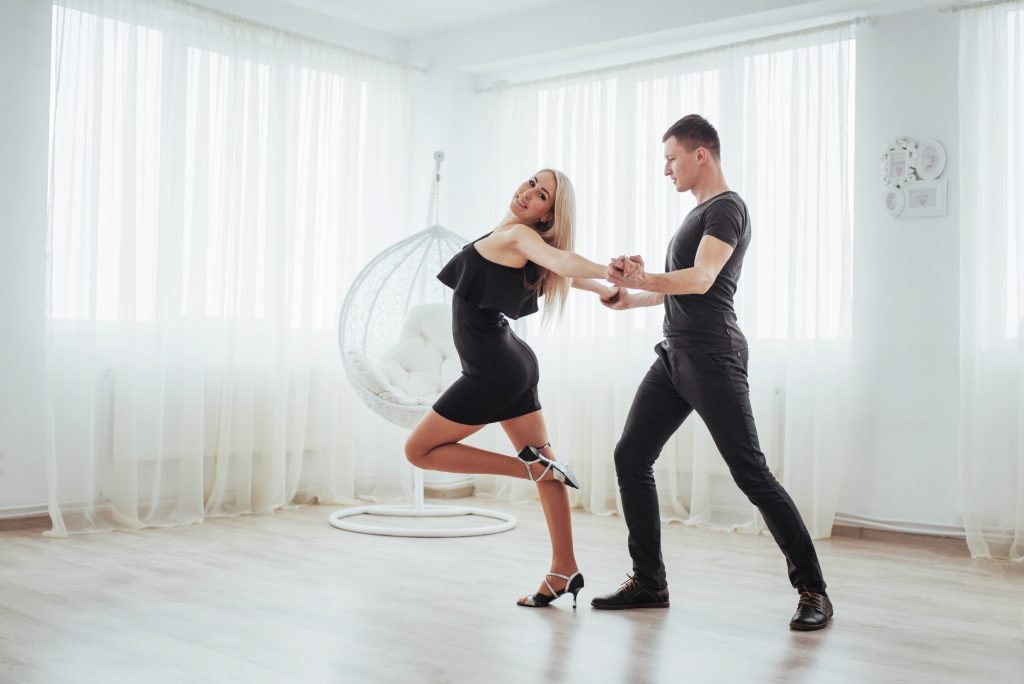 La Fiesta Dance Factory Fun Dance Classes in Sydney NSW Young Couple Dancing Latin Music: Bachata, Merengue, Salsa. Two Elegance Pose On White Room
