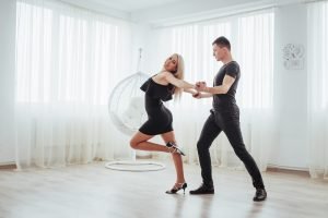 La Fiesta Dance Factory Fun Dance Classes in Sydney NSW Young Couple Dancing Latin Music: Bachata, Merengue, Salsa. Two Elegance Pose On White Room